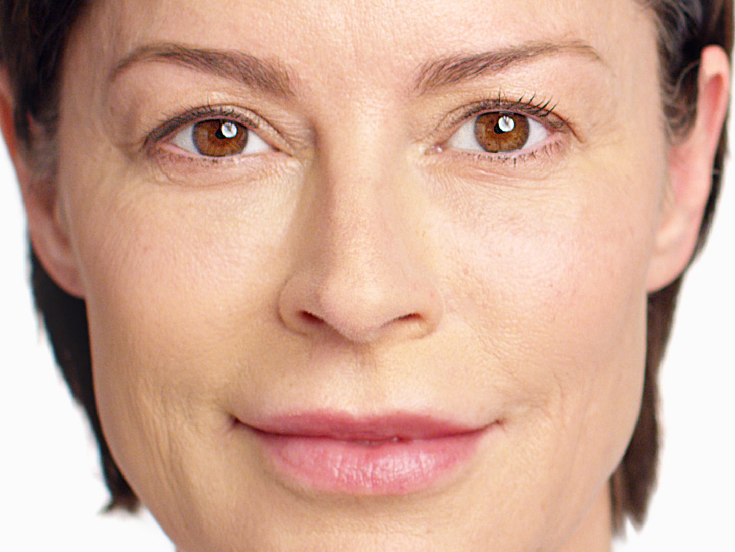close up photo of a Caucasian woman with short hair with smooth and tight facial skin