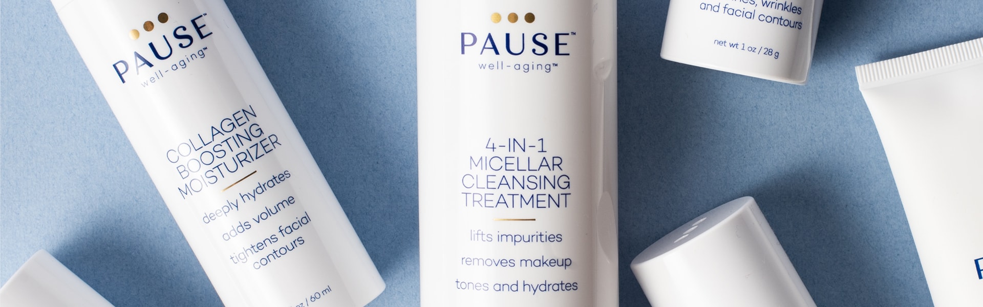 Close up image of Pause Well-Aging products shot from overhead, laying on a blue background.